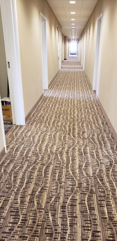 Patterned carpet installed in a hotel corridor