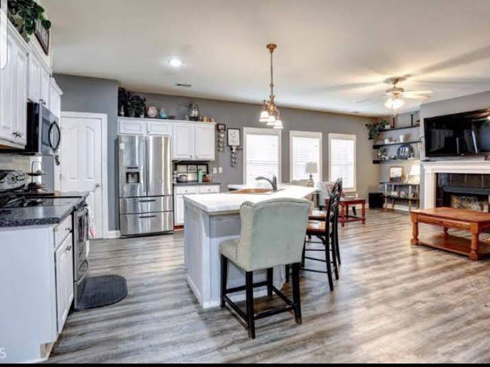 Open-plan kitchen with wood-look plank flooring